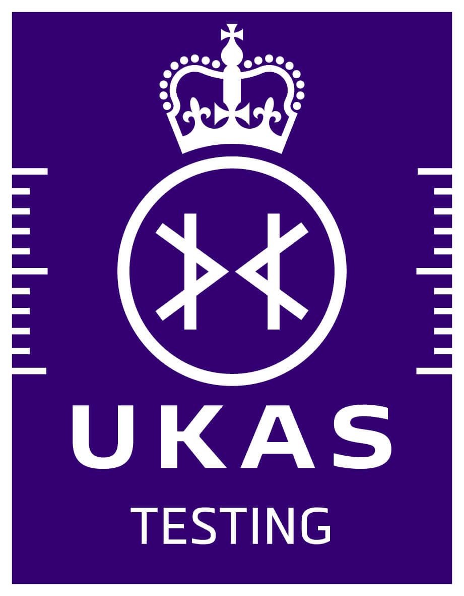 Purple UKAS Testing logo with a white crown above a circular emblem, featuring a stylised figure inside. UKAS is written in bold white letters below, with TESTING underneath it. White ruler-like markings are on each side.